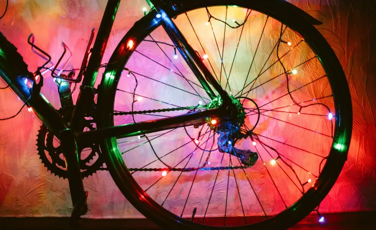 A bicycle wheel decorated with colourful lights.