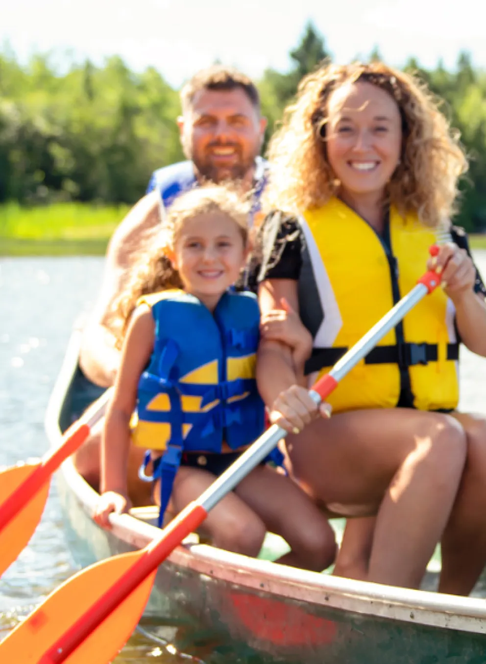 Family of four canoeing on a sunny day